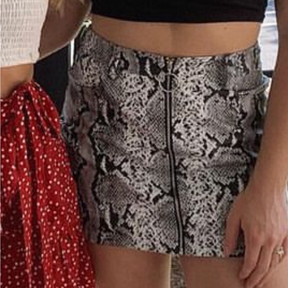 Size small snakeskin skirt!  Made of 100% polyester to give that leathery feel.